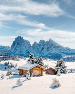 Picturesque landscape with small wooden house on meadow Alpe di Siusi