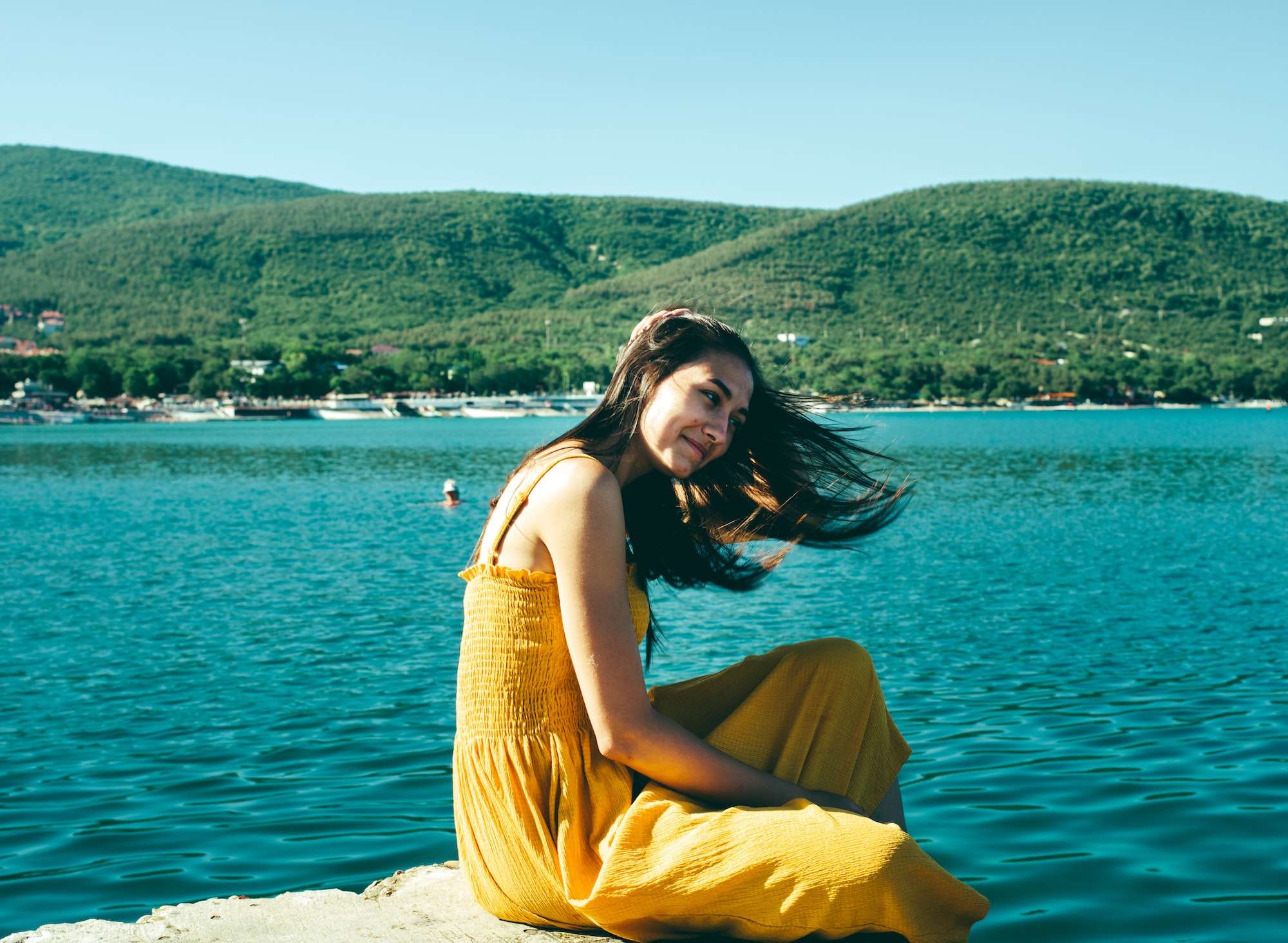 portrait-of-young-brunette-girl-with-wet-hair-in-yellow-dress-in-the-beach-summer-sea-background